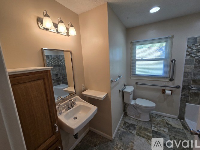 A bathroom with a sink, toilet, and tub.