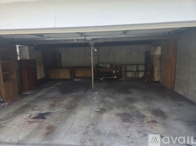 A large, empty warehouse with a concrete floor and exposed brick walls.
