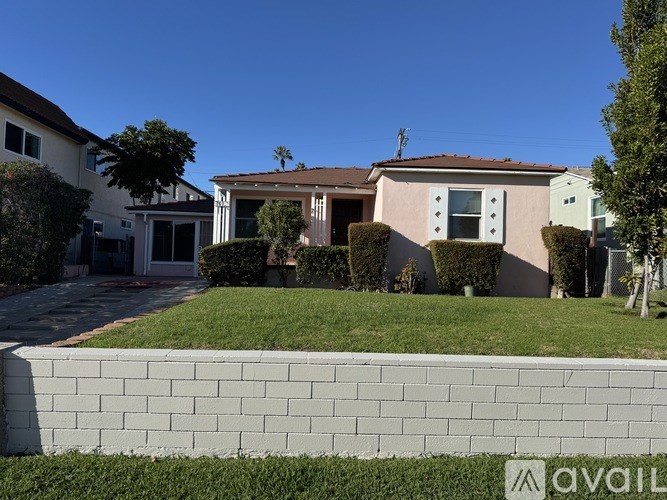 A house with a white fence in front of it.