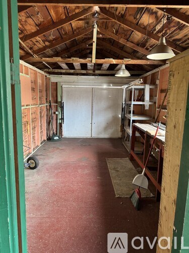 A room under construction with a white door and a broom on the floor.
