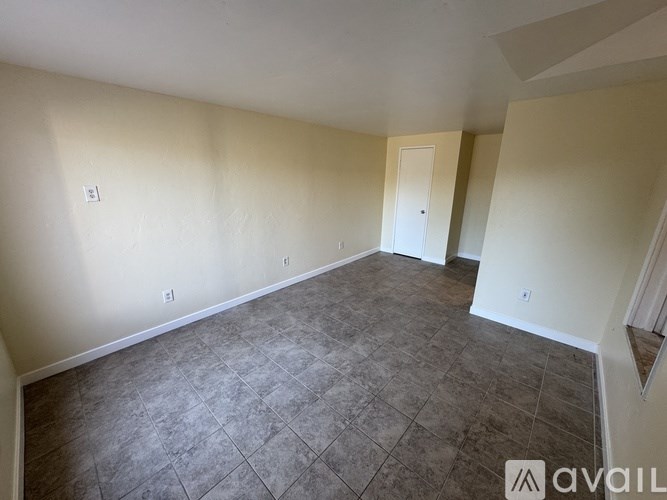 A room with tile flooring and white walls.