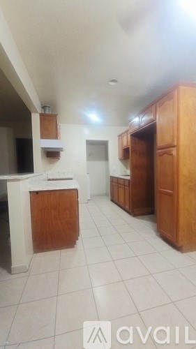 A kitchen with wooden cabinets and a white countertop.