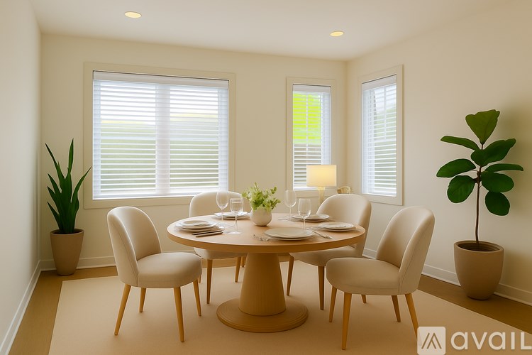 A dining room with a round table and chairs.