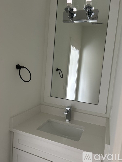 A bathroom with a sink and mirror.