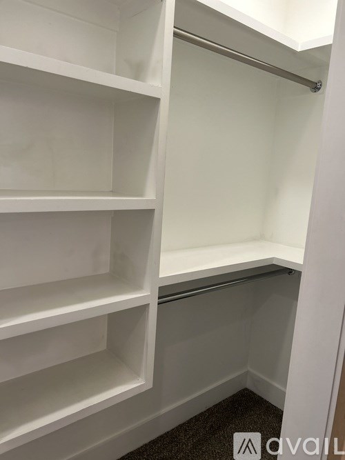 Empty white shelves in a room.