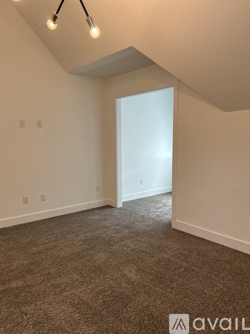 A room with carpeted floor and a window.
