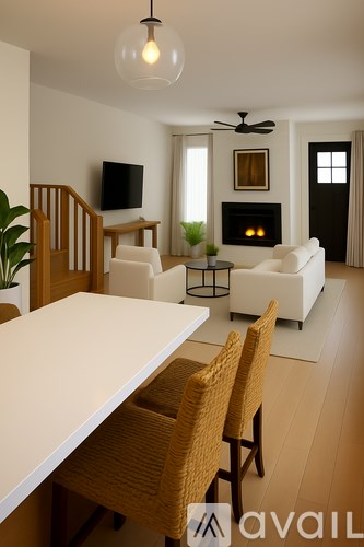 A modern living room with a fireplace and a television.