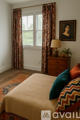 A bedroom with a bed, a dresser, a window with curtains, a lamp, and a painting on the wall.