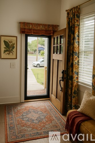 A room with a rug and a picture on the wall.