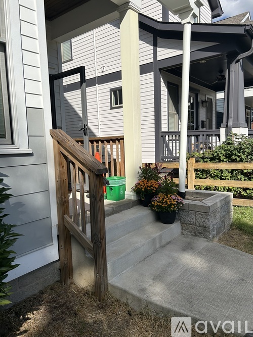 A house with a wooden front door and steps leading to the entrance.