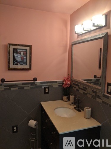 A bathroom with a sink and mirror.