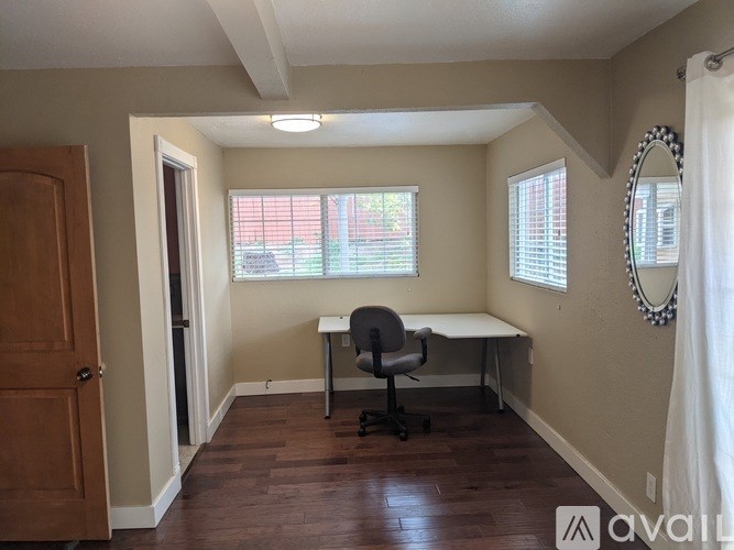 A room with a desk and a chair.