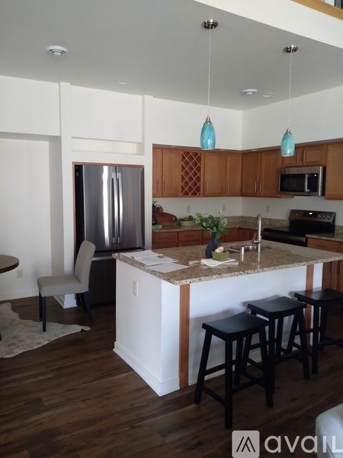 A kitchen with wooden cabinets and a white island.