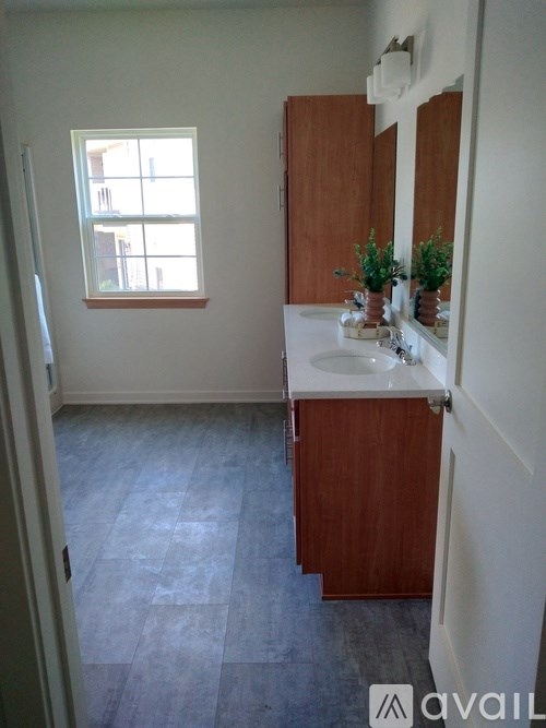 A bathroom with a window and a sink.