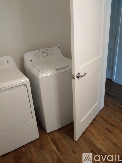 A white toilet and sink in a small room.