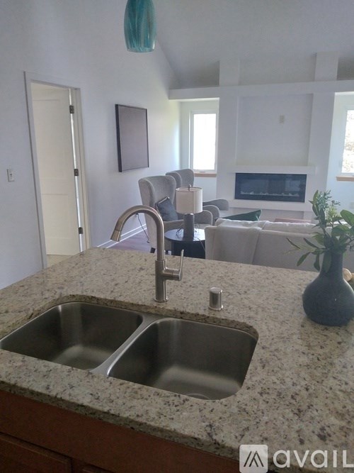 A kitchen with granite countertops and a double sink.