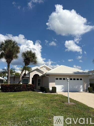 A house with a white garage door and a driveway in front.