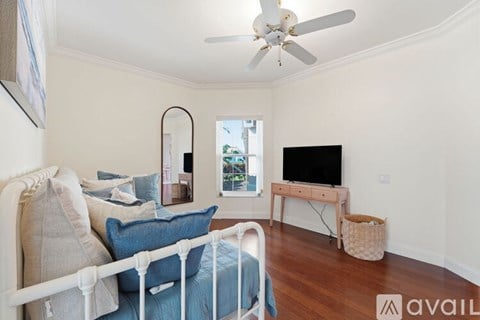 A living room with a white sofa and a television.