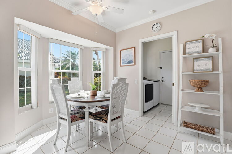 A kitchen with white cabinets and appliances.