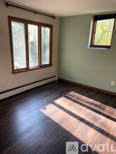 A room with wooden floors and a window.