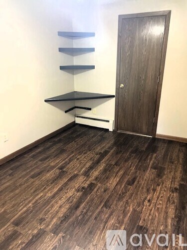 A room with a wooden floor and a door.