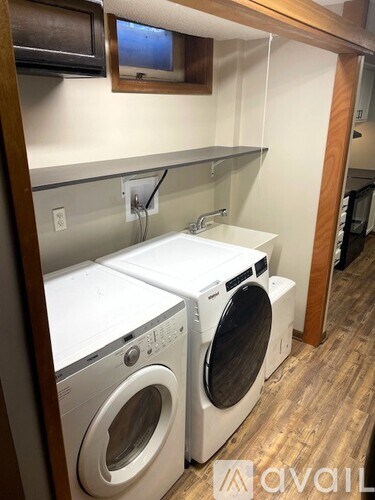 Two washing machines in a laundry room.