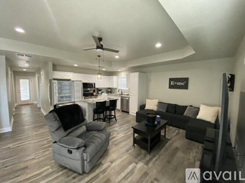 A living room with a grey sofa and a black chair.