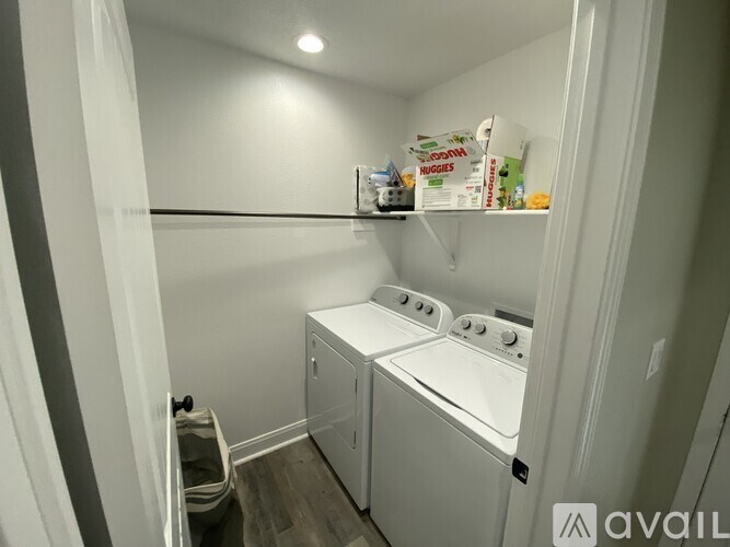 A small laundry room with a washer and dryer.