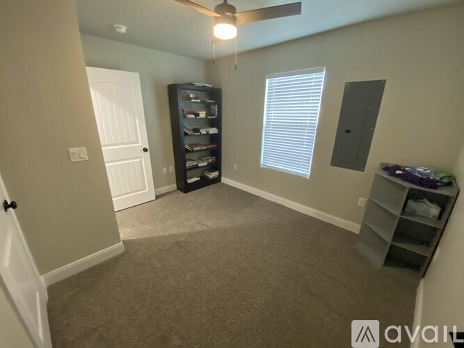 A room with a ceiling fan and a cabinet.