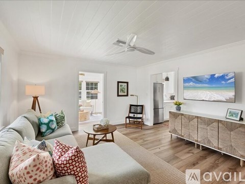 A living room with a grey sofa and a wooden cabinet.