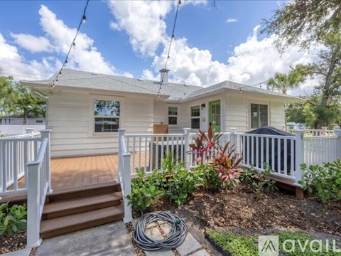 A house with a porch and a garden in front.