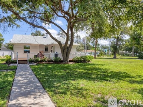 A house with a tree in front of it.