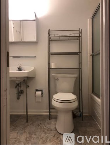 A white toilet sits next to a sink in a bathroom.
