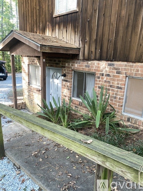 A wooden building with a white door and a window.