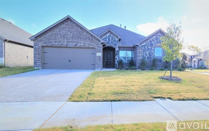 A house with a brick facade and a large garage door.