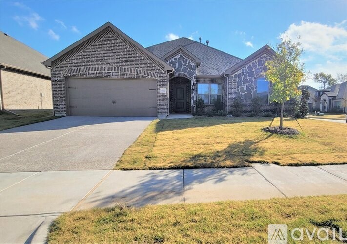 A house with a driveway and a garage is for sale.