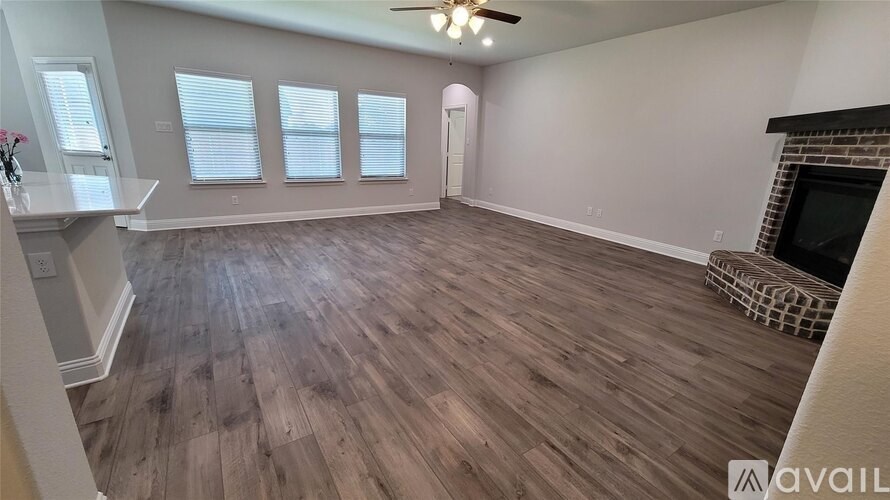 A living room with a fireplace and a chair.