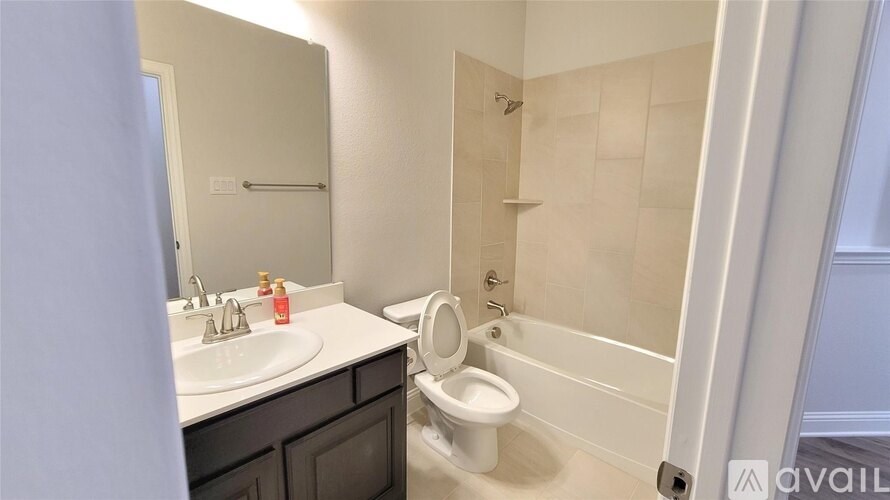 A bathroom with a sink, toilet, and shower.