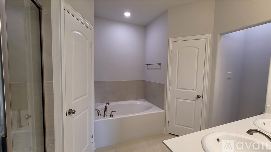 A white bathroom with a bathtub, toilet, and sink.