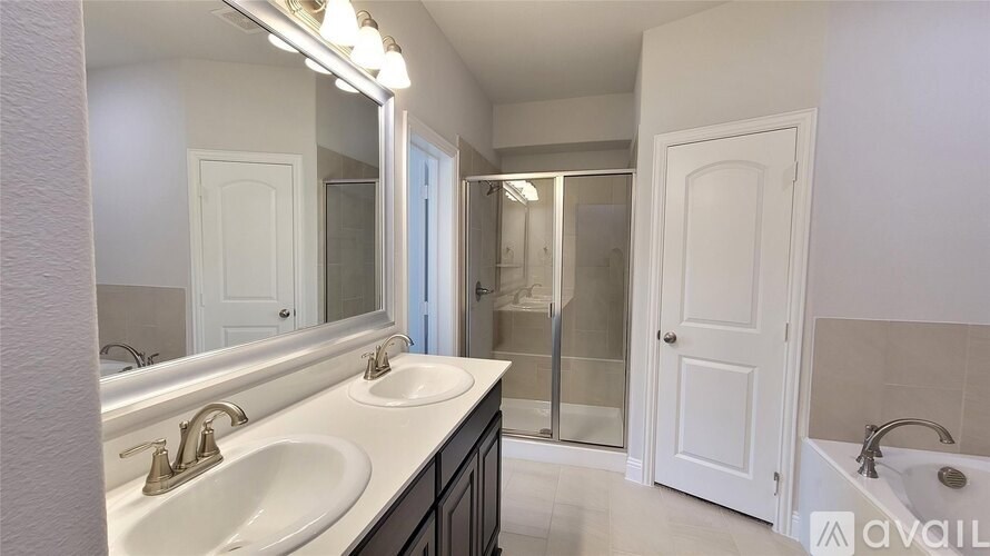 A bathroom with a white sink and mirror.
