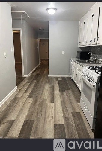 A kitchen with a stove top oven and a microwave.