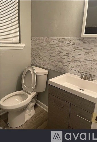 A white toilet sits next to a sink in a bathroom.