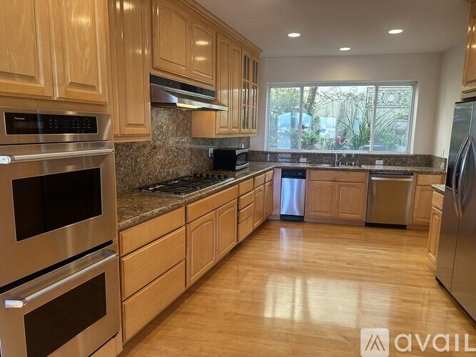 A kitchen with wooden cabinets and stainless steel appliances.