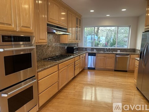 A kitchen with wooden cabinets and stainless steel appliances.
