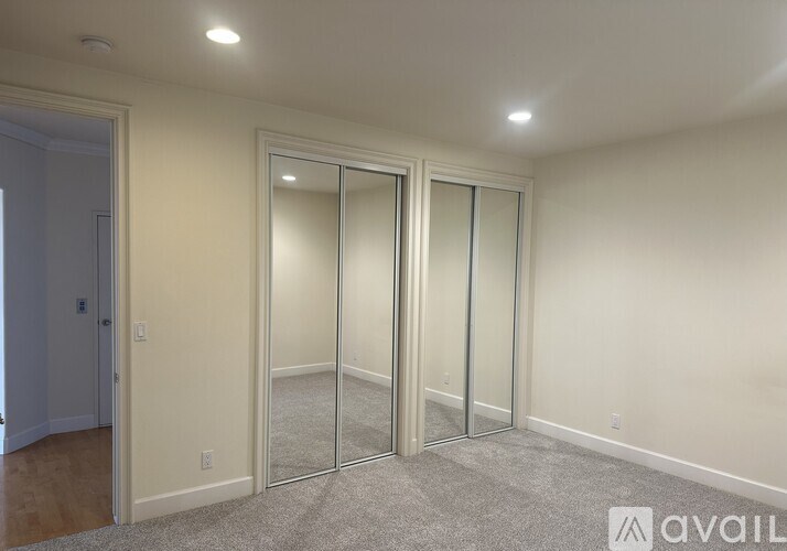 A room with a carpeted floor and a sliding glass door.