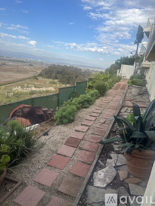 A balcony with a view of the countryside.