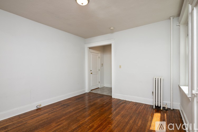 A room with wooden floors and white walls.