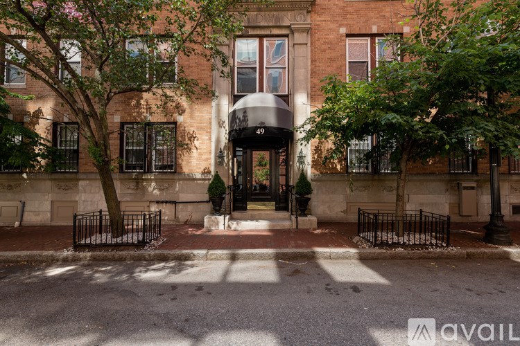 A brick building with a black gate in front.