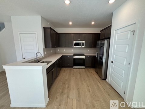 A kitchen with white cabinets and a white island.