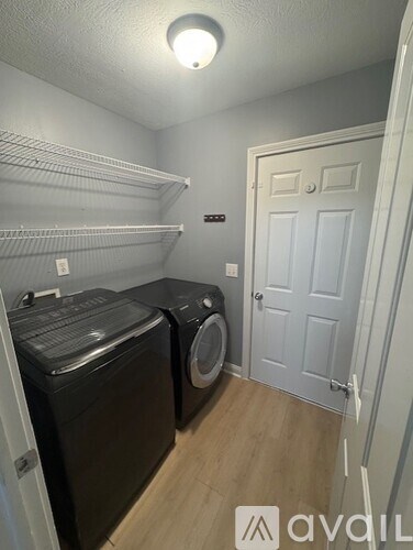 A laundry room with a washer and dryer.